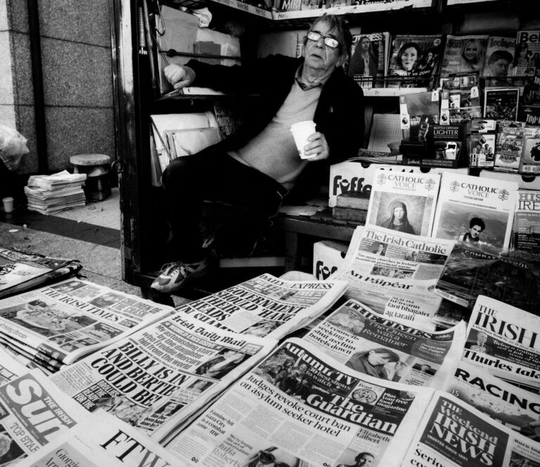 Busy UK newsstand packed with national newspapers and magazines